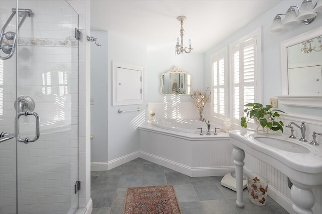 bathroom with tile patterned flooring, sink, plus walk in shower, and an inviting chandelier