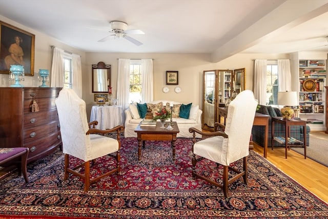 living area with hardwood / wood-style floors and ceiling fan