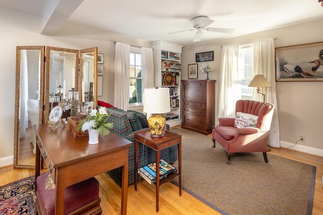 living area with ceiling fan and wood-type flooring