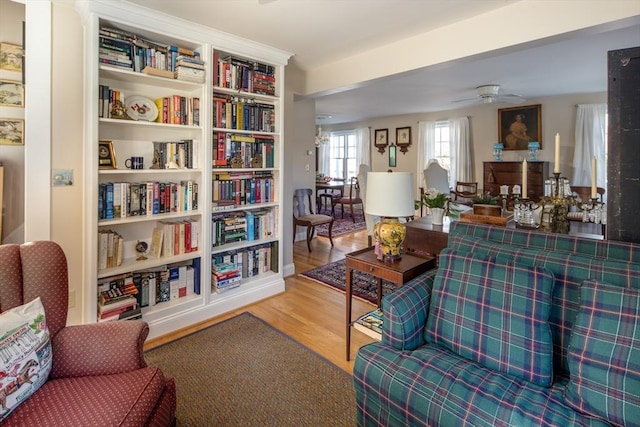 living area featuring ceiling fan and hardwood / wood-style flooring