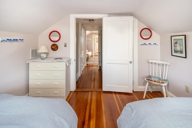 bedroom featuring wood-type flooring and vaulted ceiling