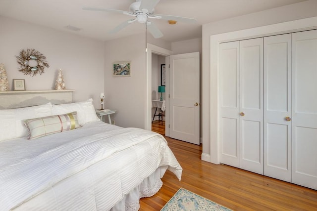 bedroom featuring ceiling fan, light wood-type flooring, and a closet