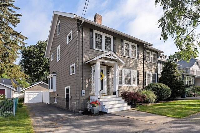 12 Moreland Rd, Quincy, MA 02169 - colonial home with a detached garage, a chimney, an outdoor structure, and driveway