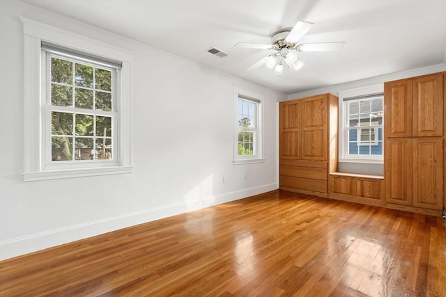 12 Moreland Rd, Quincy, MA 02169 - unfurnished bedroom with multiple windows, light wood-type flooring, and ceiling fan