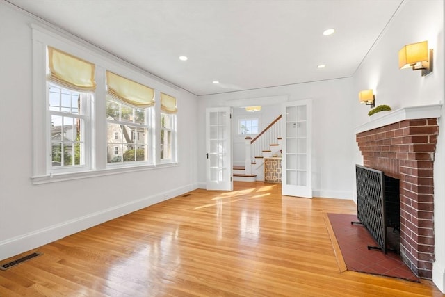12 Moreland Rd, Quincy, MA 02169 - unfurnished living room featuring light wood-style flooring, a fireplace, stairs, ornamental molding, and recessed lighting
