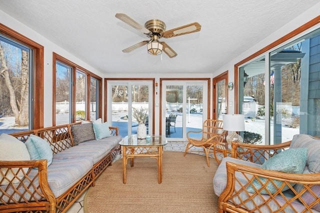 sunroom featuring ceiling fan