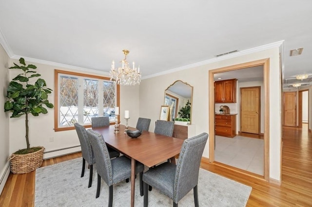 dining area featuring a baseboard radiator, ornamental molding, an inviting chandelier, and light hardwood / wood-style flooring