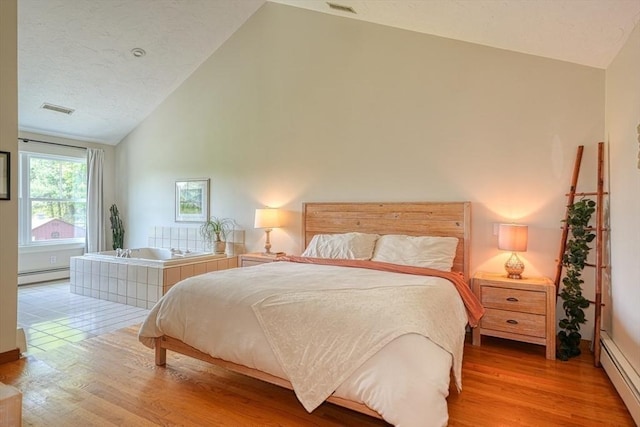 161 Randall Rd, Berlin, MA 01503 - bedroom featuring baseboard heating, light wood-style flooring, high vaulted ceiling, and baseboards