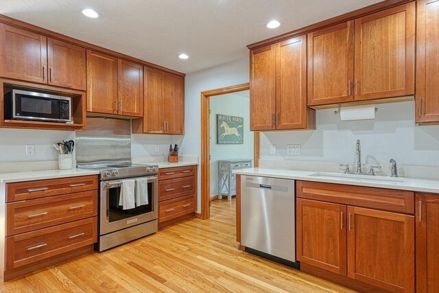 161 Randall Rd, Berlin, MA 01503 - kitchen featuring appliances with stainless steel finishes, a sink, brown cabinetry, and recessed lighting