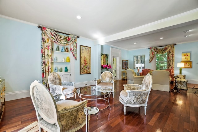 sitting room featuring ornamental molding and dark hardwood / wood-style flooring