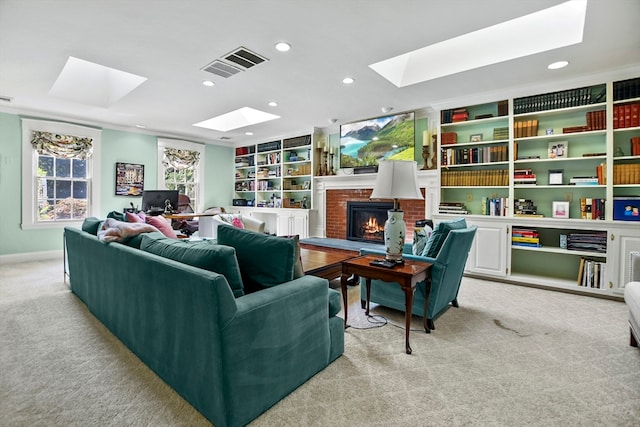 carpeted living room featuring a brick fireplace and a skylight