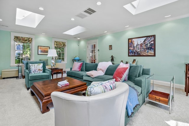 living room featuring ornamental molding, light carpet, and a skylight