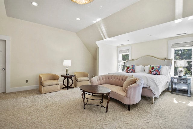 bedroom with vaulted ceiling and light carpet