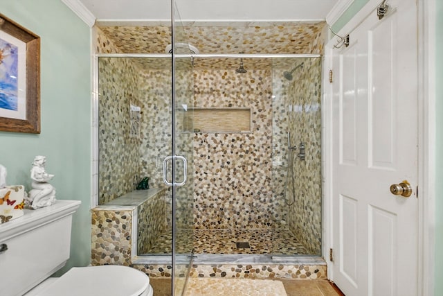 bathroom with walk in shower, crown molding, toilet, and tile patterned floors