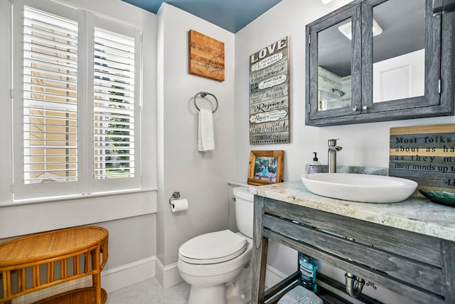 bathroom featuring vanity, toilet, and tile patterned floors