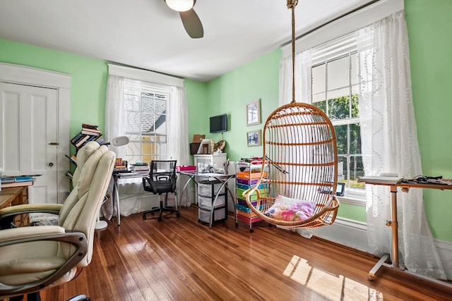 home office with ceiling fan, hardwood / wood-style flooring, and a wealth of natural light