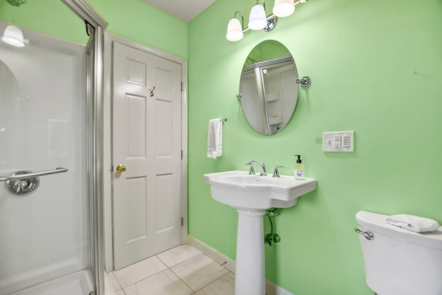 bathroom featuring walk in shower and toilet