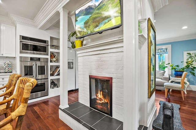 living room featuring a brick fireplace, crown molding, and dark wood-type flooring