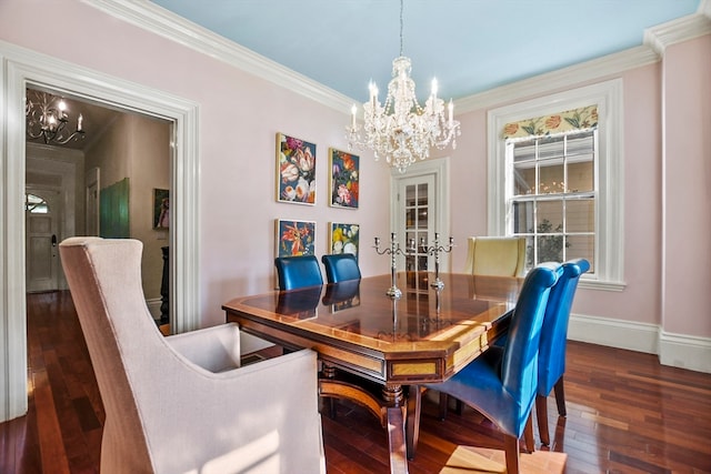 dining space featuring crown molding, an inviting chandelier, and dark hardwood / wood-style flooring