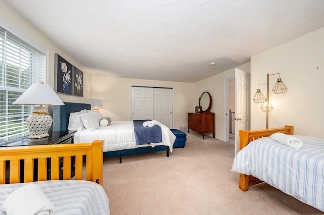 carpeted bedroom with a closet