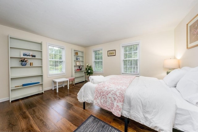 bedroom with dark hardwood / wood-style flooring