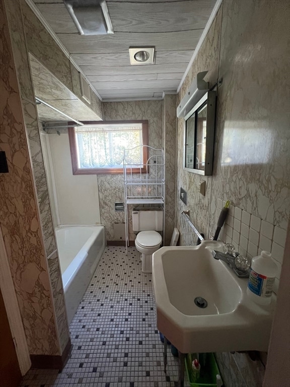 bathroom featuring toilet, crown molding, a bath, and tile patterned flooring