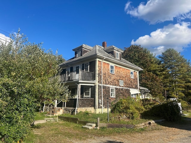 back of property with a balcony