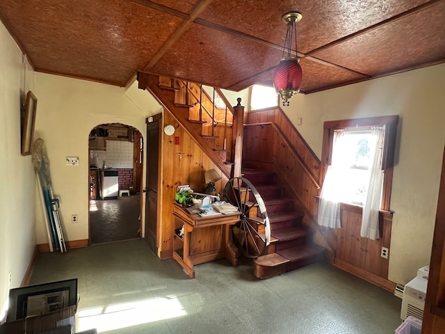 stairway featuring wood walls