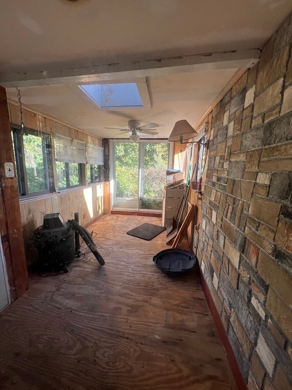 interior space featuring a skylight and ceiling fan