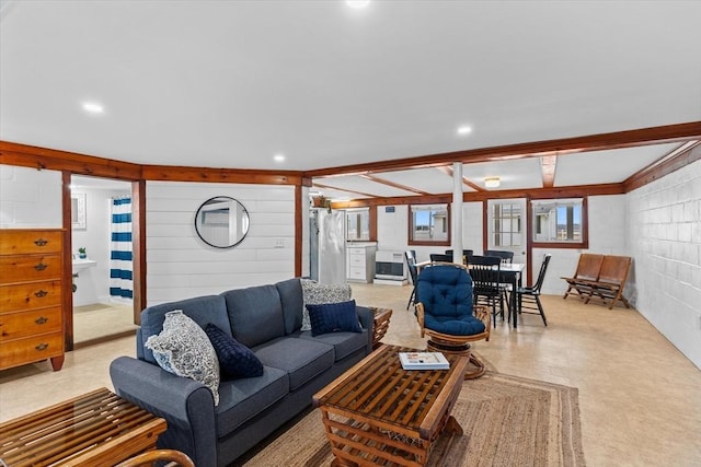 living room featuring concrete block wall, heating unit, and recessed lighting