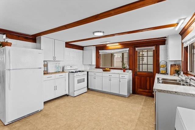 kitchen featuring light countertops, a sink, white cabinets, and white appliances