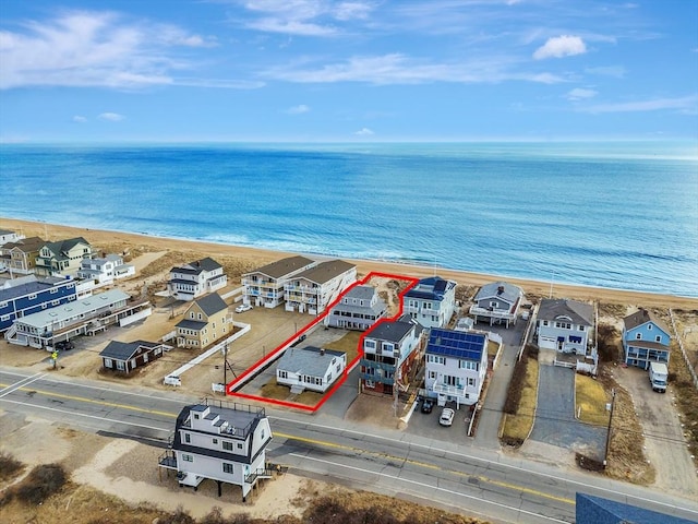 aerial view featuring a water view, a residential view, and a view of the beach