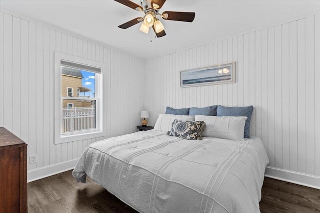 bedroom featuring baseboards, a ceiling fan, and wood finished floors