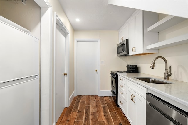 kitchen featuring white cabinetry, sink, dark wood-type flooring, and appliances with stainless steel finishes