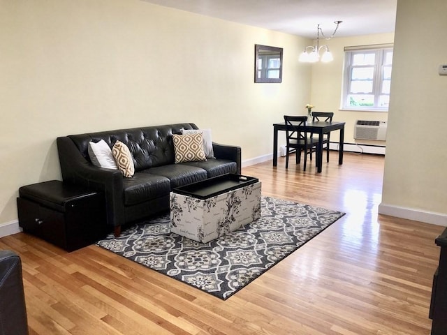 4 Emerson Gardens Rd Unit 4, Lexington, MA 02420 - living area featuring wood finished floors, a chandelier, baseboards, a wall unit AC, and baseboard heating