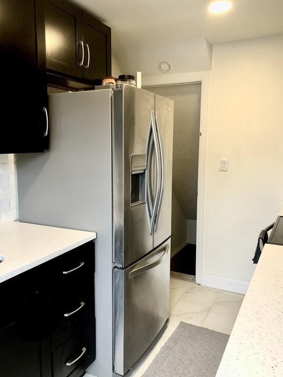 4 Emerson Gardens Rd Unit 4, Lexington, MA 02420 - kitchen featuring stainless steel fridge, light countertops, baseboards, and light marble finish floors