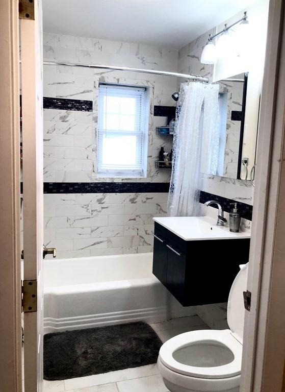 4 Emerson Gardens Rd Unit 4, Lexington, MA 02420 - bathroom featuring toilet, shower / bath combination with curtain, vanity, and tile patterned floors