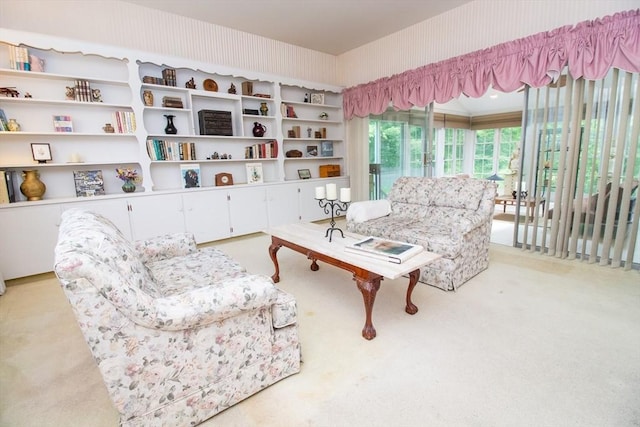 living area featuring light carpet