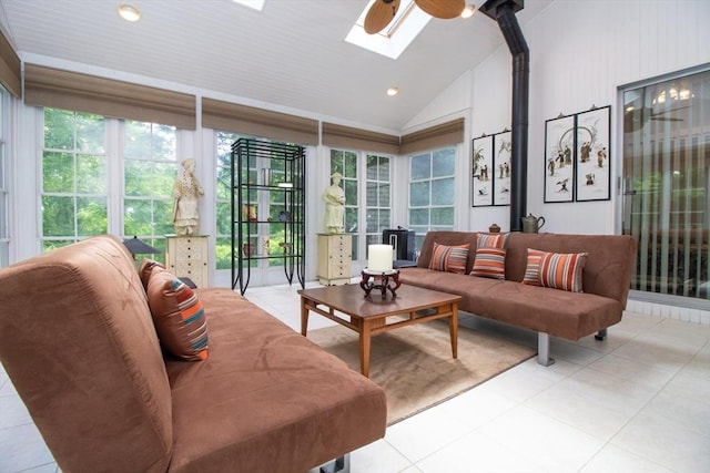 interior space featuring lofted ceiling with skylight and ceiling fan