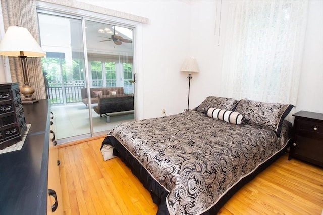 bedroom with wood-type flooring and access to outside