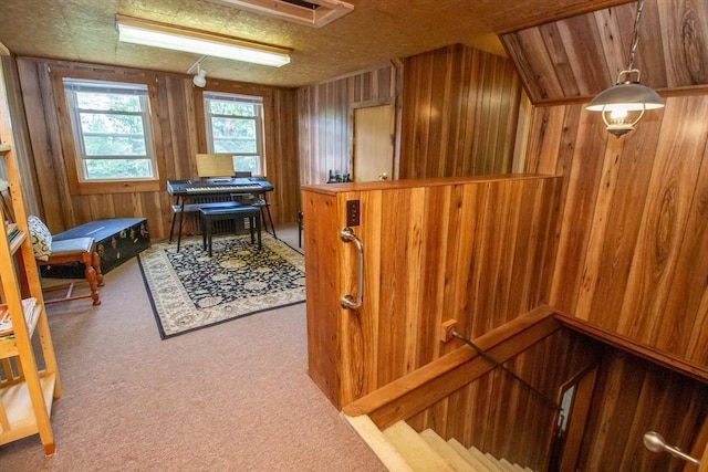 interior space featuring carpet and wooden walls