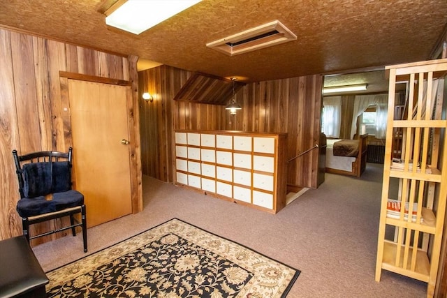 interior space with carpet floors and wood walls