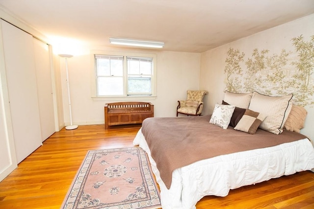 bedroom featuring hardwood / wood-style flooring and a closet