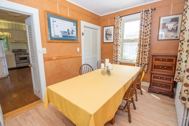 dining area featuring crown molding and wood-type flooring