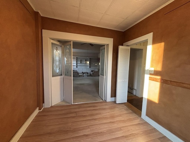 hallway with a baseboard radiator and light wood-type flooring