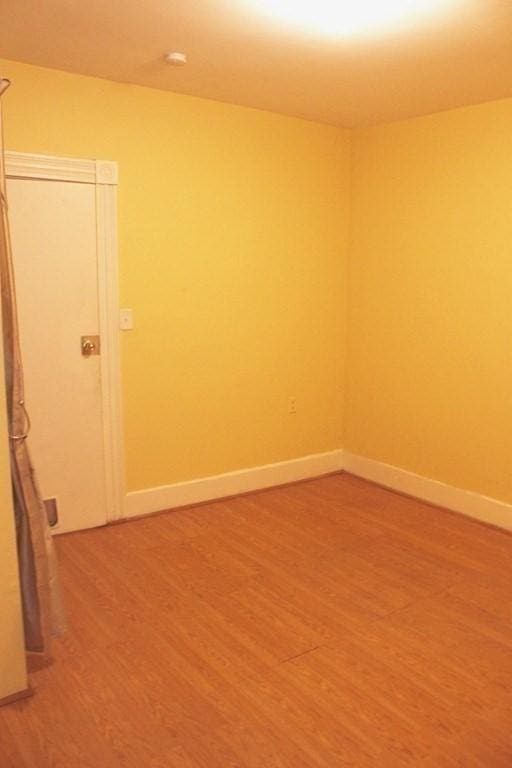 unfurnished room featuring hardwood / wood-style flooring