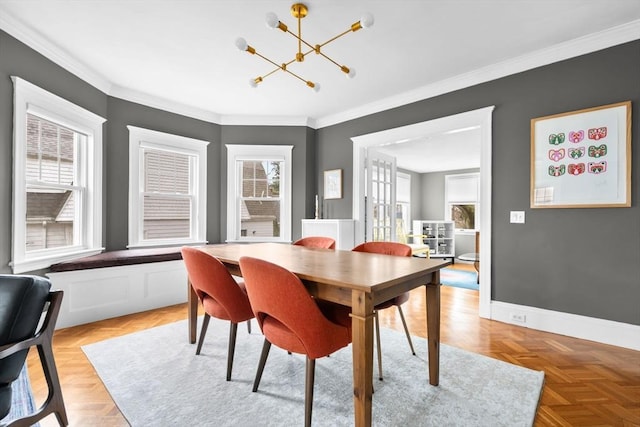 dining area with crown molding, a notable chandelier, and baseboards