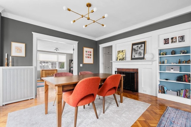 dining space featuring an inviting chandelier, a fireplace, and crown molding