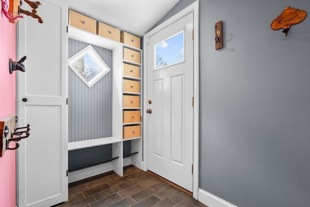 mudroom featuring dark wood-style floors, baseboards, and vaulted ceiling