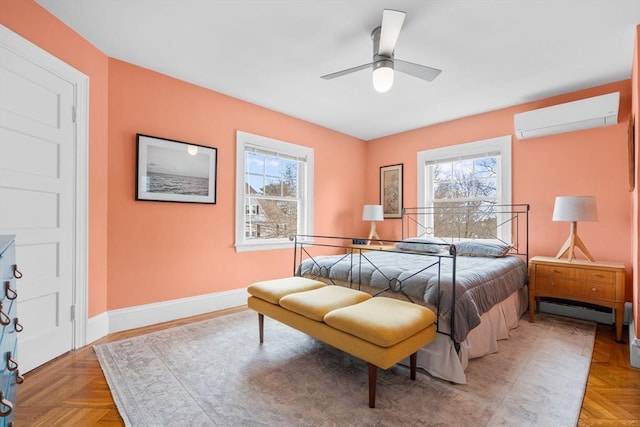 bedroom featuring baseboards, a wall unit AC, a ceiling fan, and a baseboard radiator